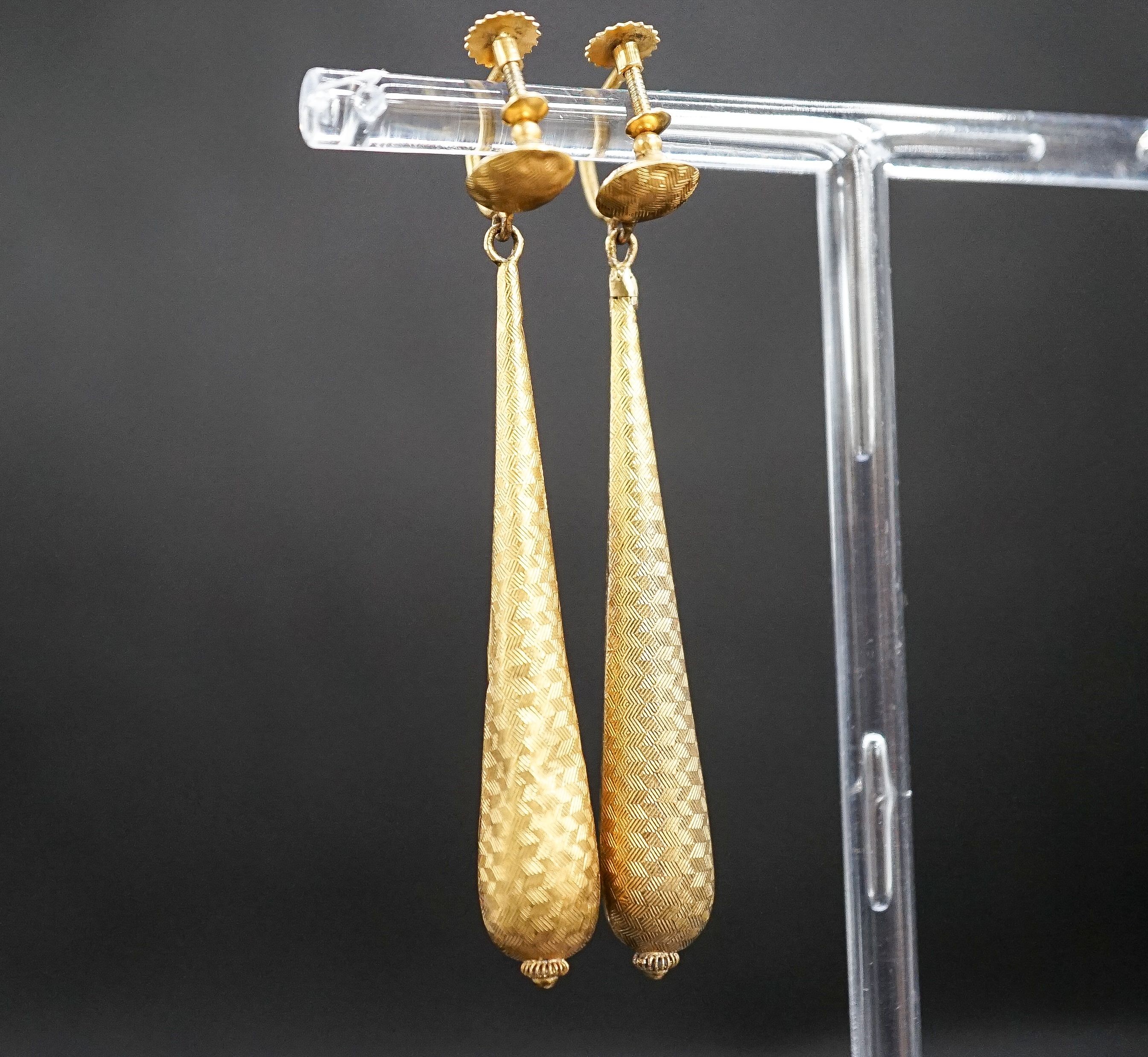 A pair of hollow, yellow metal teardrop shaped earrings, (a.f.), 6cm, 3.3 grams.